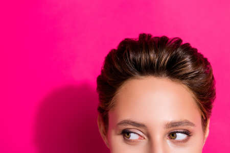 Cropped view portrait of attractive curious girl looking aside copy space isolated over bright pink...