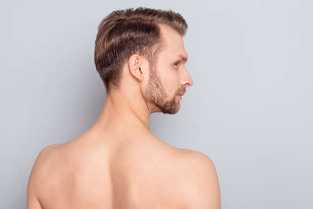 Rear back behind view portrait of attractive nude man modern complexion isolated over grey pastel color backgroundの写真素材