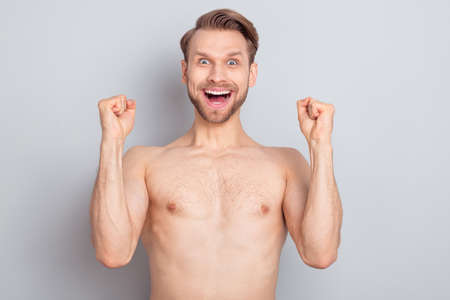 Photo of hooray young blond man hands fists without clothes isolated on grey color backgroundの写真素材