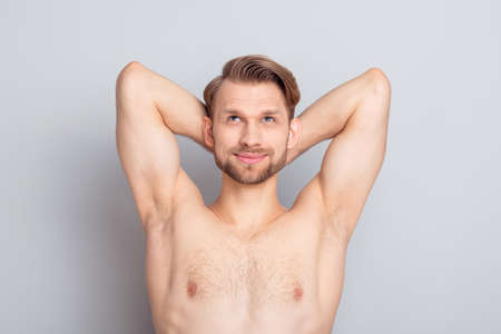 Photo of macho blond hairdo guy look empty space without clothes isolated on grey color backgroundの写真素材
