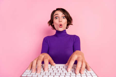 Photo of astonished brunette millennial lady type wear violet pullover isolated on pink color backgroundの写真素材