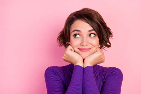 Photo of nice brunette millennial lady look empty space wear violet jumper isolated on pink color...