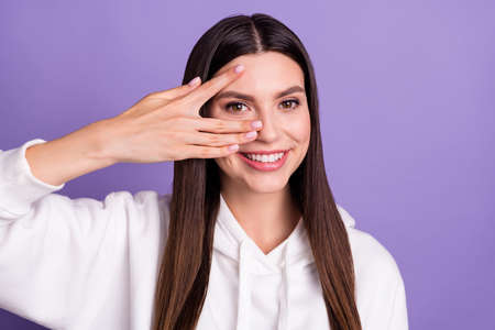 Photo of young happy positive cheerful woman hold hand face fingers smile isolated on purple color backgroundの写真素材