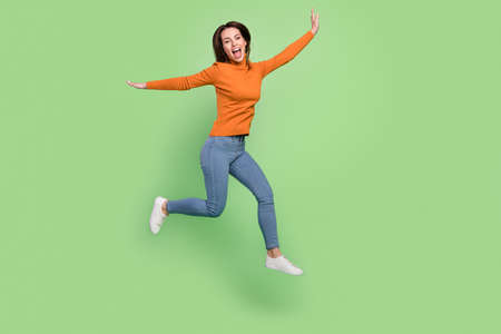 Full length body size view of attractive cheerful thin girl jumping having fun walking running...