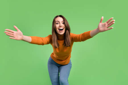 Portrait of attractive cheerful glad kind girl having fun dancing hugging you isolated over green color backgroundの写真素材