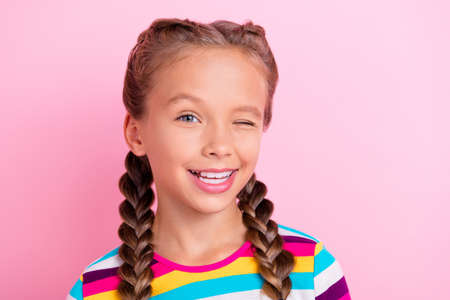 Photo of flirty positive lady look camera blink eye beaming smile wear striped shirt isolated pink color backgroundの写真素材