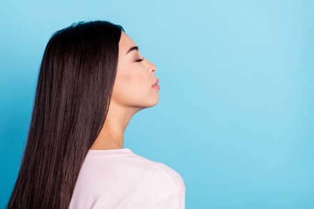 Profile side photo of cheerful flawless dream young woman closed eyes enjoy isolated on blue color backgroundの写真素材