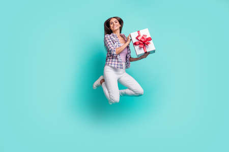 Full body photo of funny young brunette lady jump with present wear shirt trousers sneakers isolated...