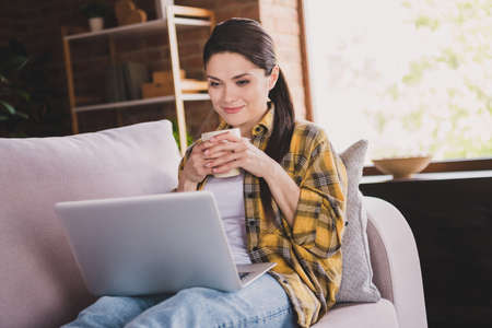 Portrait of attractive positive person arms hold tea mug enjoy serials spend free time vacation home...