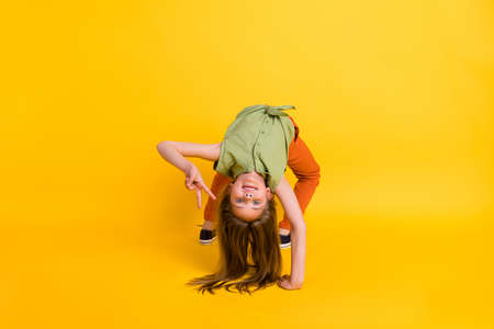 Full body photo of crazy blond small girl do sport wear blouse trousers isolated on yellow color...