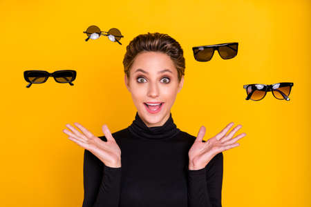 Portrait of attractive amazed cheerful girl choosing news specs wow discount isolated over bright...
