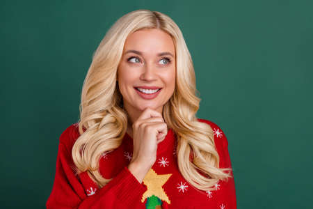 Photo of minded young happy positive woman look empty space idea plan isolated on green color backgroundの写真素材