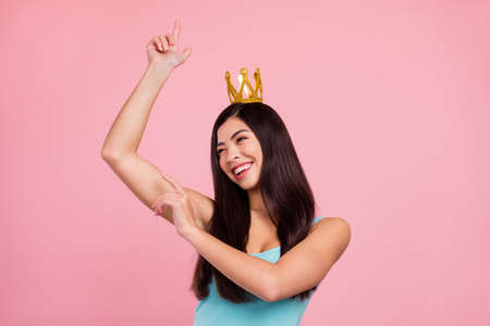 Photo of sweet young long hairdo lady dance wear crown blue top isolated on pastel pink color backgroundの写真素材
