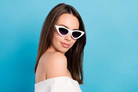 Profile photo of nice brunette young lady wear spectacles white top isolated on blue color backgroundの写真素材