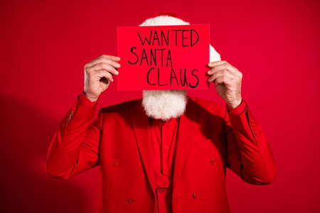 Photo of shy retired man dressed christmas costume hat hiding behind wanted santa claus placard...