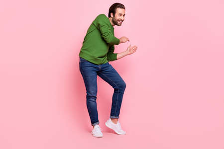 Full length photo of positive glad people dancing look empty space beaming smile isolated on pink color backgroundの写真素材