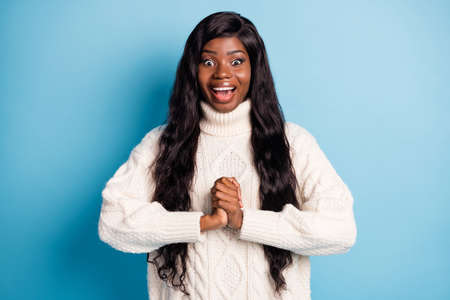 Portrait of impressed positive dark skin person folded arms palms open mouth isolated on blue color backgroundの写真素材