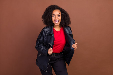 Photo of carefree cheerful young person open mouth have good mood isolated on brown color backgroundの写真素材