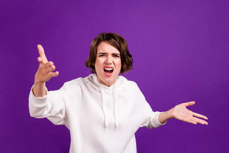Photo portrait girl wearing hoody shouting angry arguing isolated bright pastel color backgroundの写真素材
