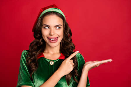 Photo portrait female elf pointing finger copyspace licking lips isolated vivid red color background copyspaceの写真素材