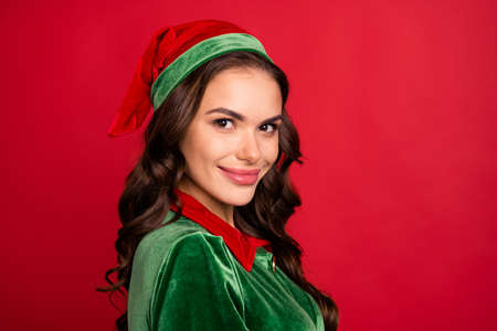 Photo portrait woman in elf outfit smiling in headwear isolated bright red color backgroundの写真素材