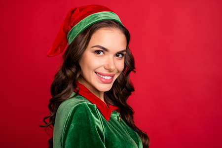 Photo of cheerful pretty lovely lady shiny smile look camera wear elf costume hat isolated red color backgroundの写真素材