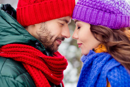 Photo of adorable dreamy girlfriend boyfriend dressed vests smiling closed eyes touching foreheads...