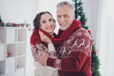 Photo of cute couple aged lady man hug wear sweater scarf at homeの写真素材