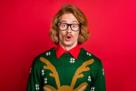 Portrait of attractive funky amazed guy news reaction eve day time isolated over bright red color backgroundの写真素材