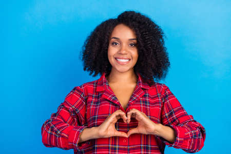 Photo of flirty young lady show heart wear red checkered pajama isolated on blue color background