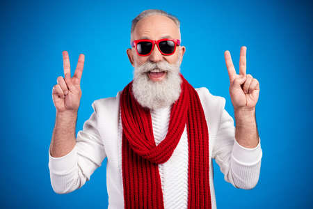 Photo of funky age gentleman wear white red sweater red eyewear smiling showing v-sign isolated blue color backgroundの写真素材
