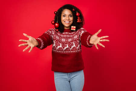 Portrait of attractive cheerful girl wearing decor in hair hugging you eve day welcome isolated over shine red color backgroundの写真素材
