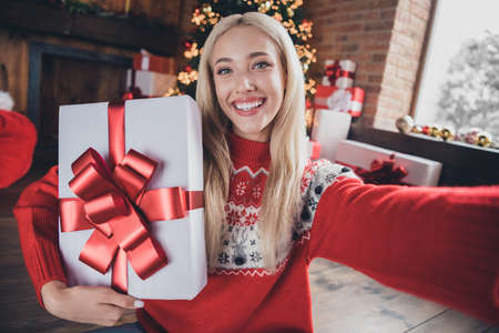 Photo of young cheerful girl happy positive smile make selfie present box winter holiday christmas spirit indoorsの写真素材