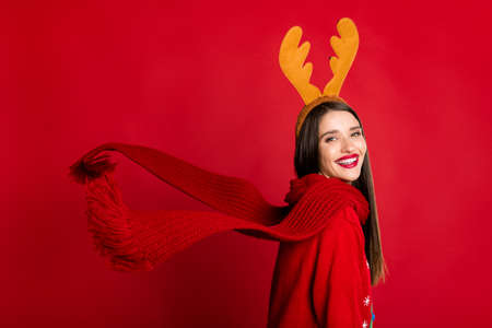 Photo of pretty charming young woman dressed ugly pullover scarf smiling isolated red color backgroundの写真素材