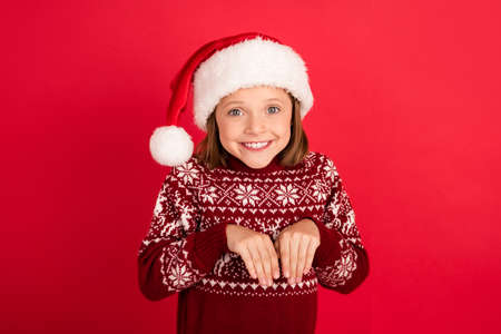 Photo of young little girl happy positive smile hands paws playful pet noel isolated over red color backgroundの写真素材