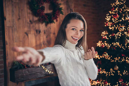 Photo of charming pretty young woman dressed knitted sweater dancing smiling indoors room home houseの写真素材