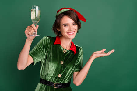 Photo of cheerful lady drink champagne congratulations event wear elf costume hat isolated green...
