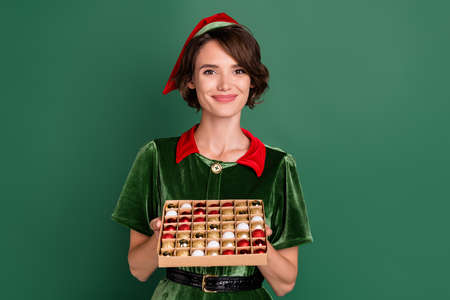 Portrait of attractive cheerful girl holding festal tree balls advent newyear eve fairy isolated...
