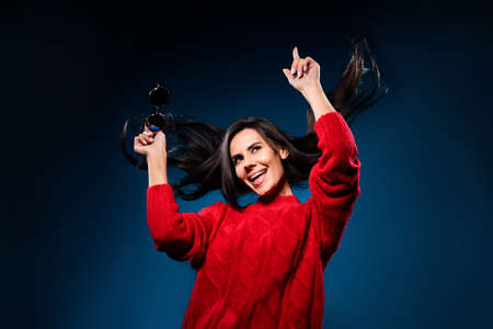 Photo of adorable charming young woman dressed red pullover dancing pointing finger smiling isolated...