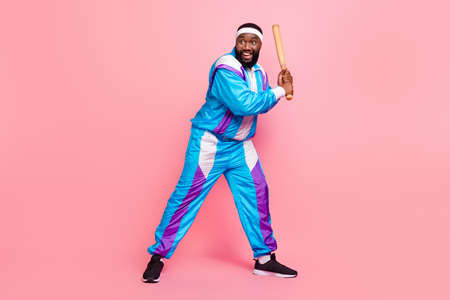 Photo of strong funky dark skin man wear blue suit headband holding baseball bat looking empty space smiling isolated pink color backgroundの写真素材