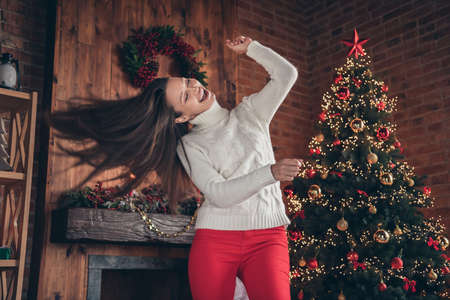 Photo of cute funny young lady wear white pullover smiling dancing indoors house home room