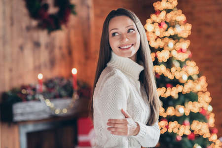 Photo of adorable shiny young lady wear knitted sweater smiling indoors house home roomの写真素材