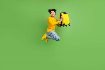 Full length body size photo man jumping up with suitcase isolated pastel pink color background