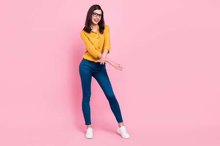 Full size photo of pretty brunette hairdo millennial lady dance wear shirt eyewear trousers sneakers isolated on pink backgroundの写真素材