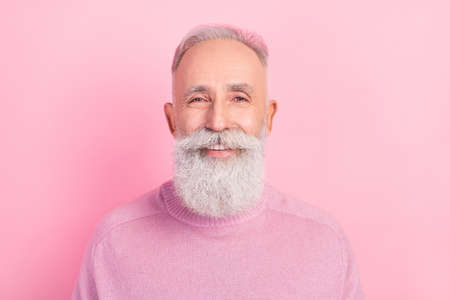 Photo of cheerful grey hair senior man wear pink sweater isolated on pastel color backgroundの写真素材