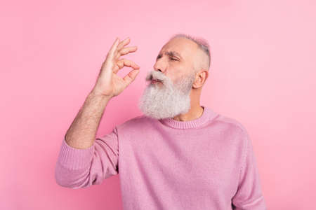 Profile photo of funny grey beard old man taste food wear pink sweater isolated on pastel color...