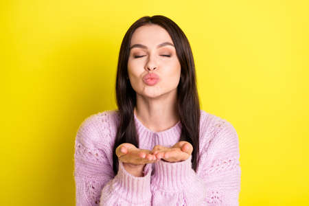 Photo of romantic nice brown hairdo lady blow kiss wear pink sweater isolated on vivid yellow color...