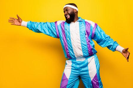 Photo of young afro man happy positive smile show hands measure size length isolated over yellow color backgroundの写真素材