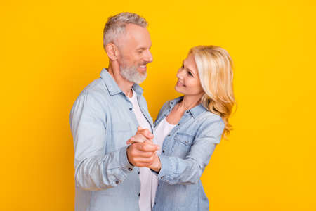 Photo of old cheerful positive people couple dance good mood enjoy harmony love isolated on yellow color backgroundの写真素材