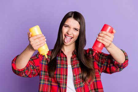 Photo of cool brunette hairdo young lady push sauces tongue out wear red shirt isolated on purple color backgroundの写真素材